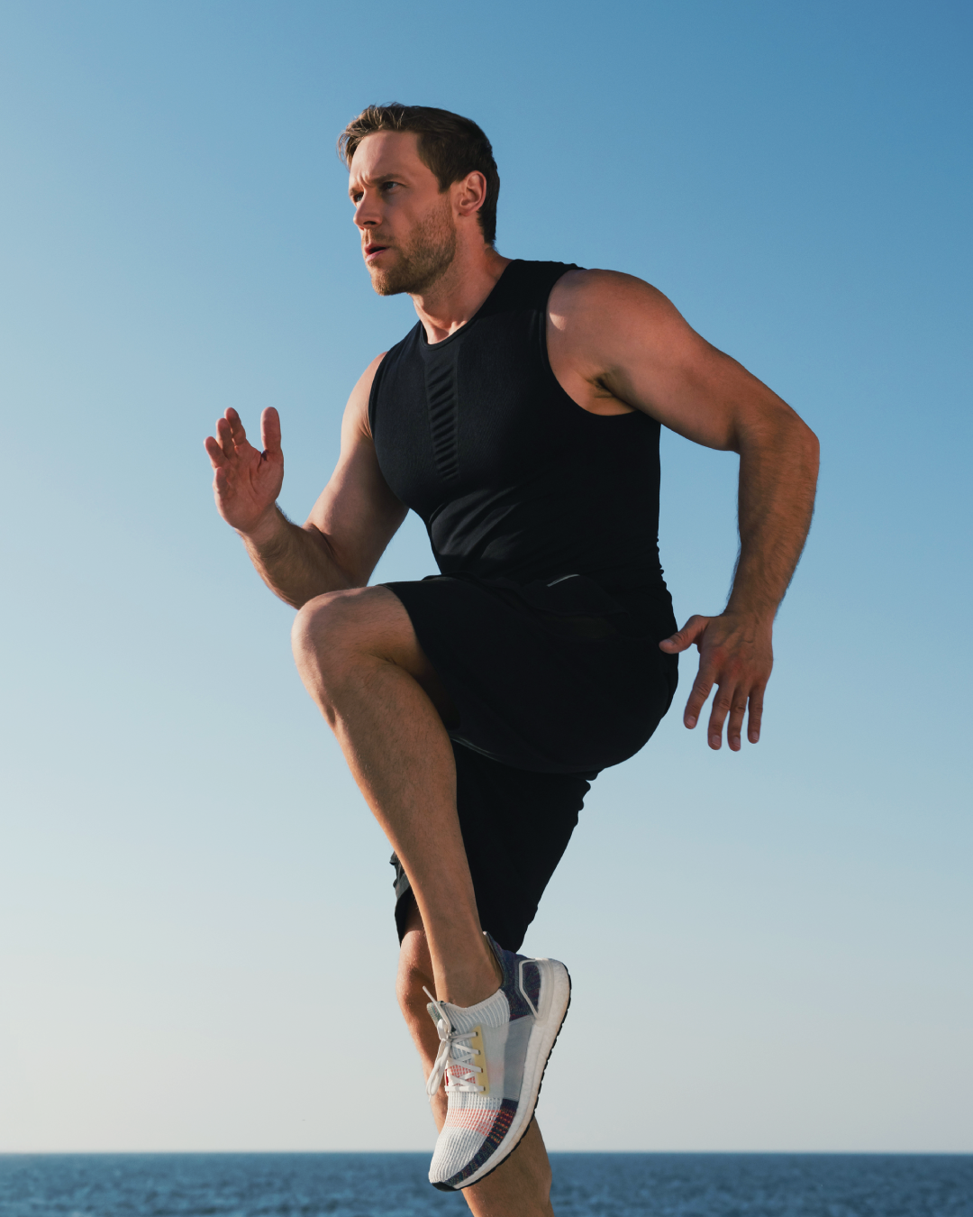 Runner training outdoors against a clear blue sky